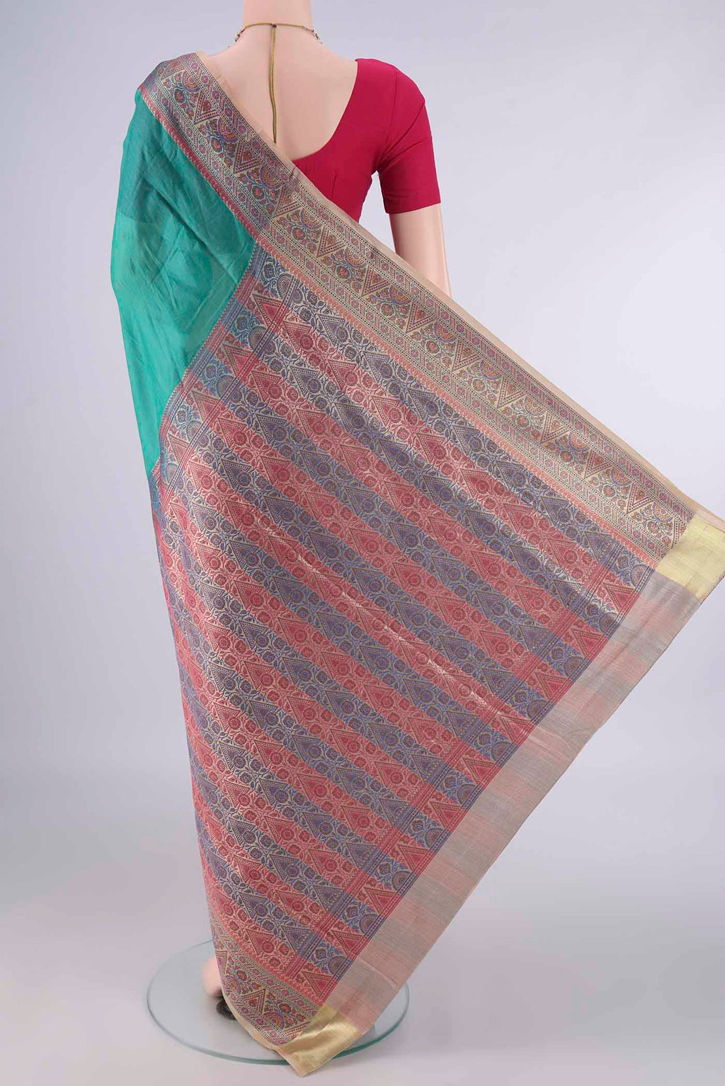 Flat view of Green Banarasi Tussar Saree with Plain Body and Zari Border. 