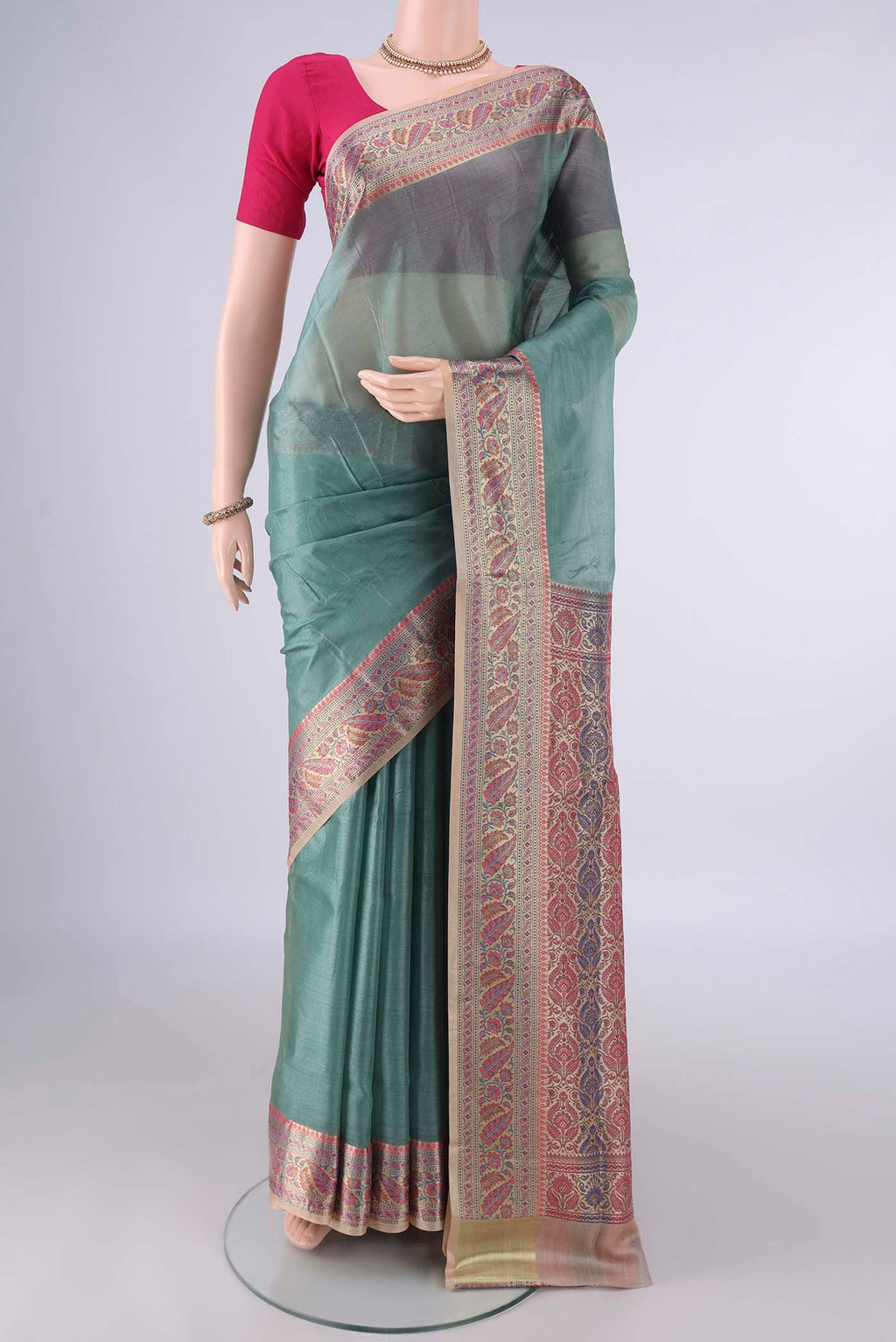 Light Green Banarasi Tussar Saree with Plain Body and Zari Border.  displayed on a mannequin