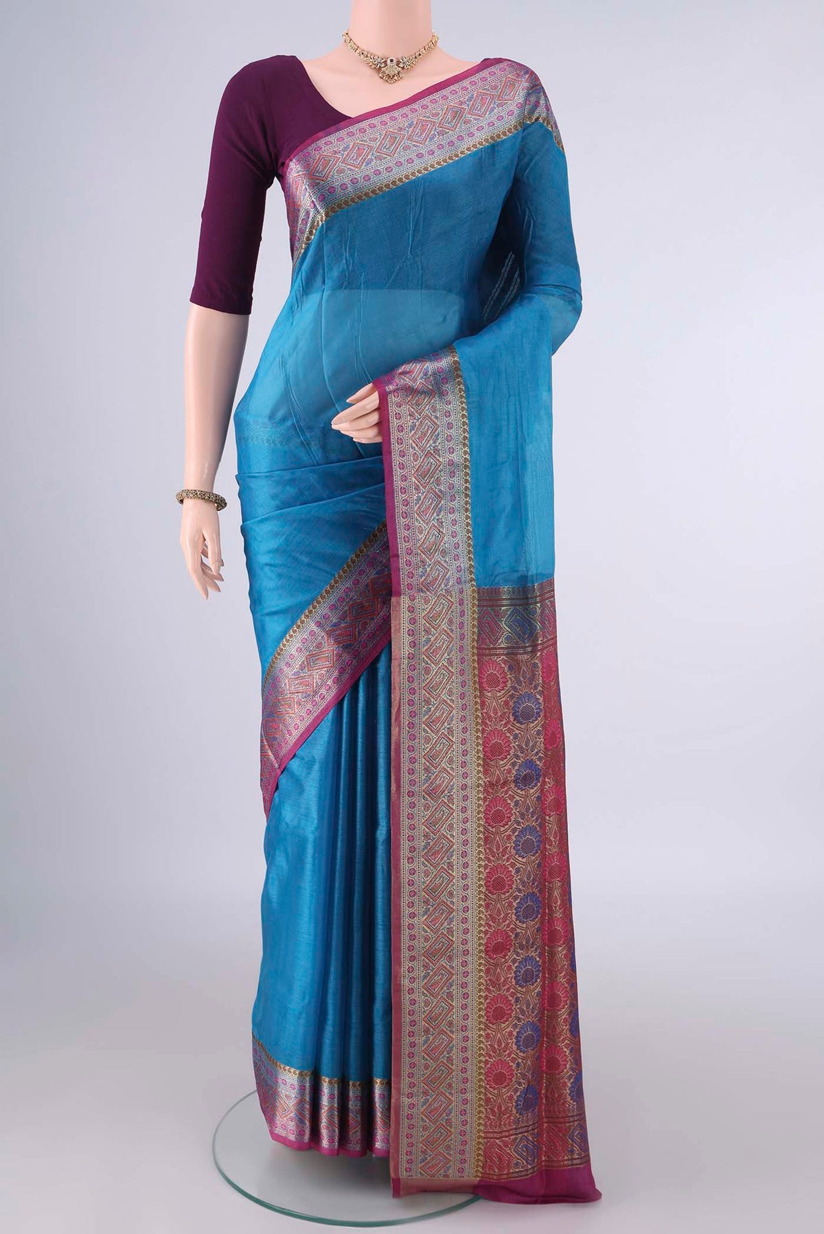 Blue Banarasi Tussar Saree with Plain Body and Zari Border.  displayed on a mannequin