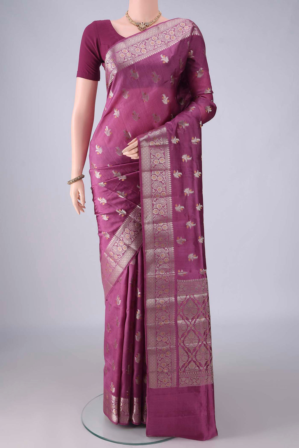 Pure Silk Mauve Banarasi Raw Saree with Zari And Thread Butta on the body and Zari Border.  displayed on a mannequin
