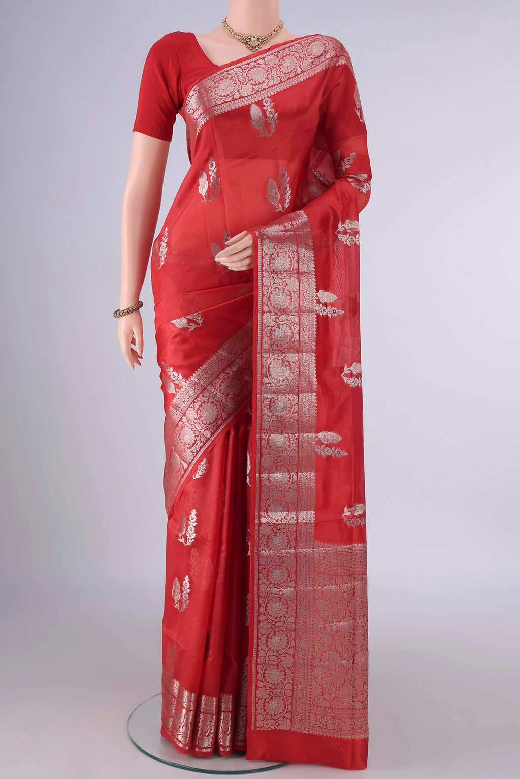Pure Silk Red Banarasi Raw Saree with Zari And Thread Butta on the body and Zari Border.  displayed on a mannequin