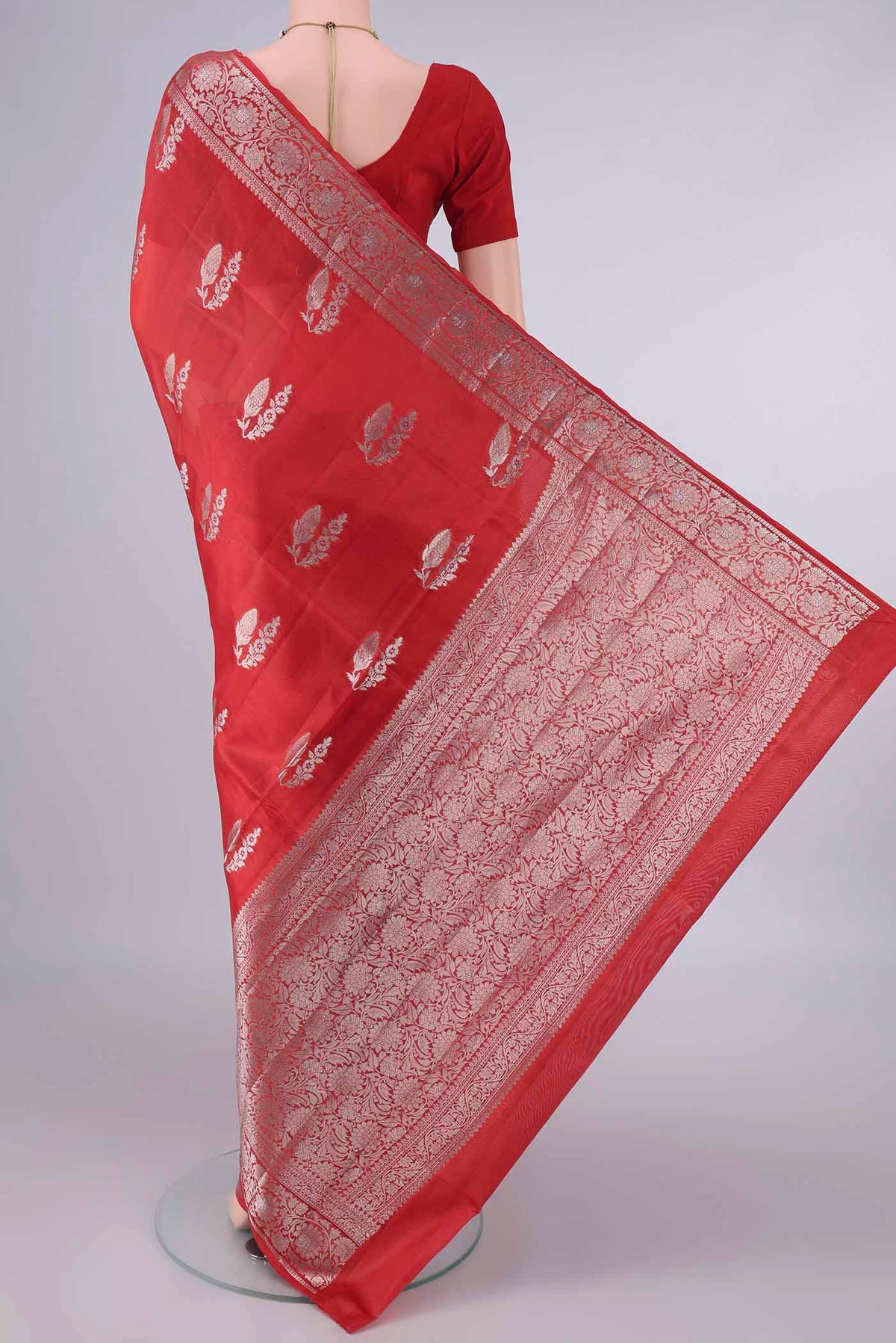 Flat view of Pure Silk Red Banarasi Raw Saree with Zari And Thread Butta on the body and Zari Border. 