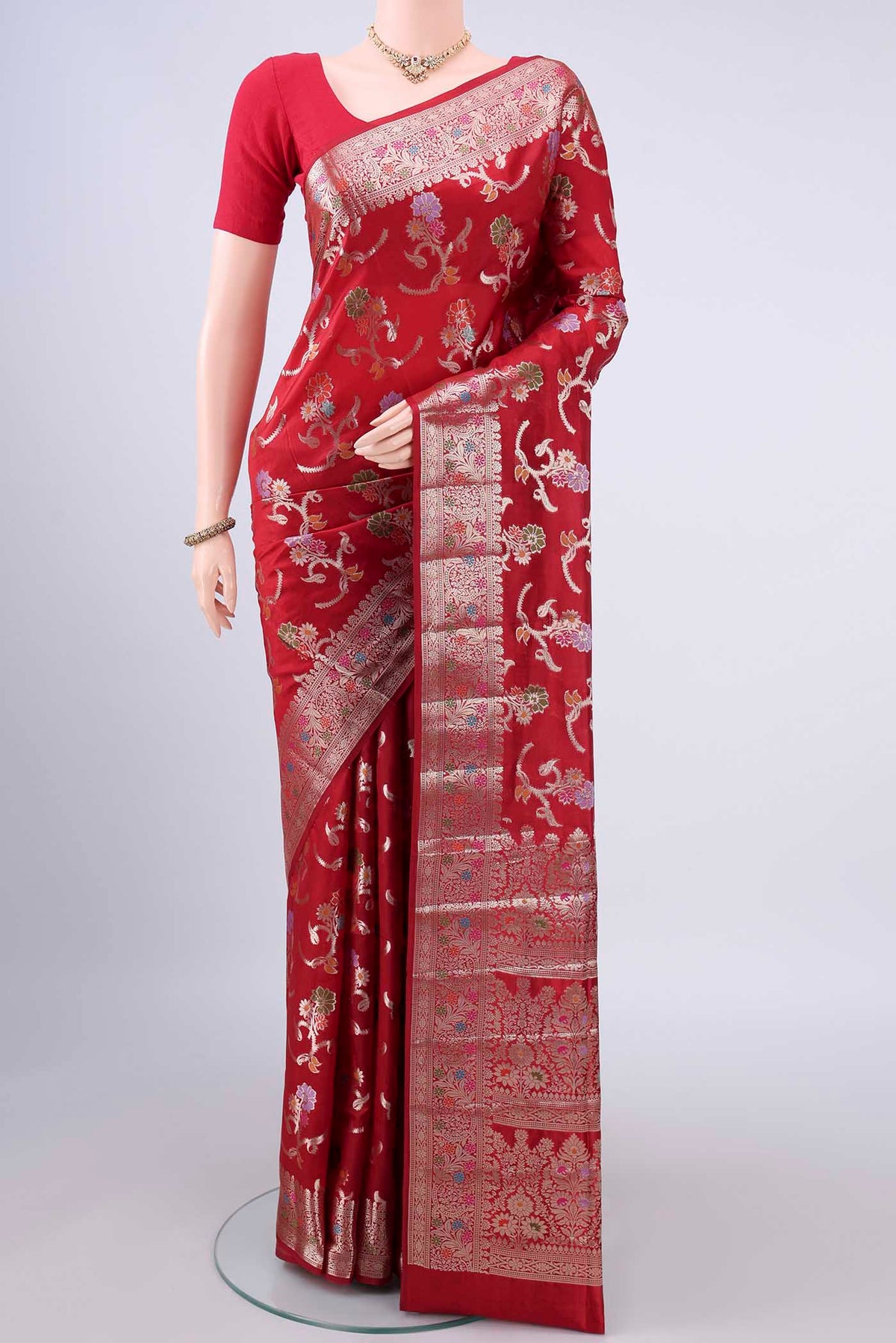 Pure Silk Red Banarasi Raw Saree with Zari And Thread Butta on the body and Zari Border.  displayed on a mannequin