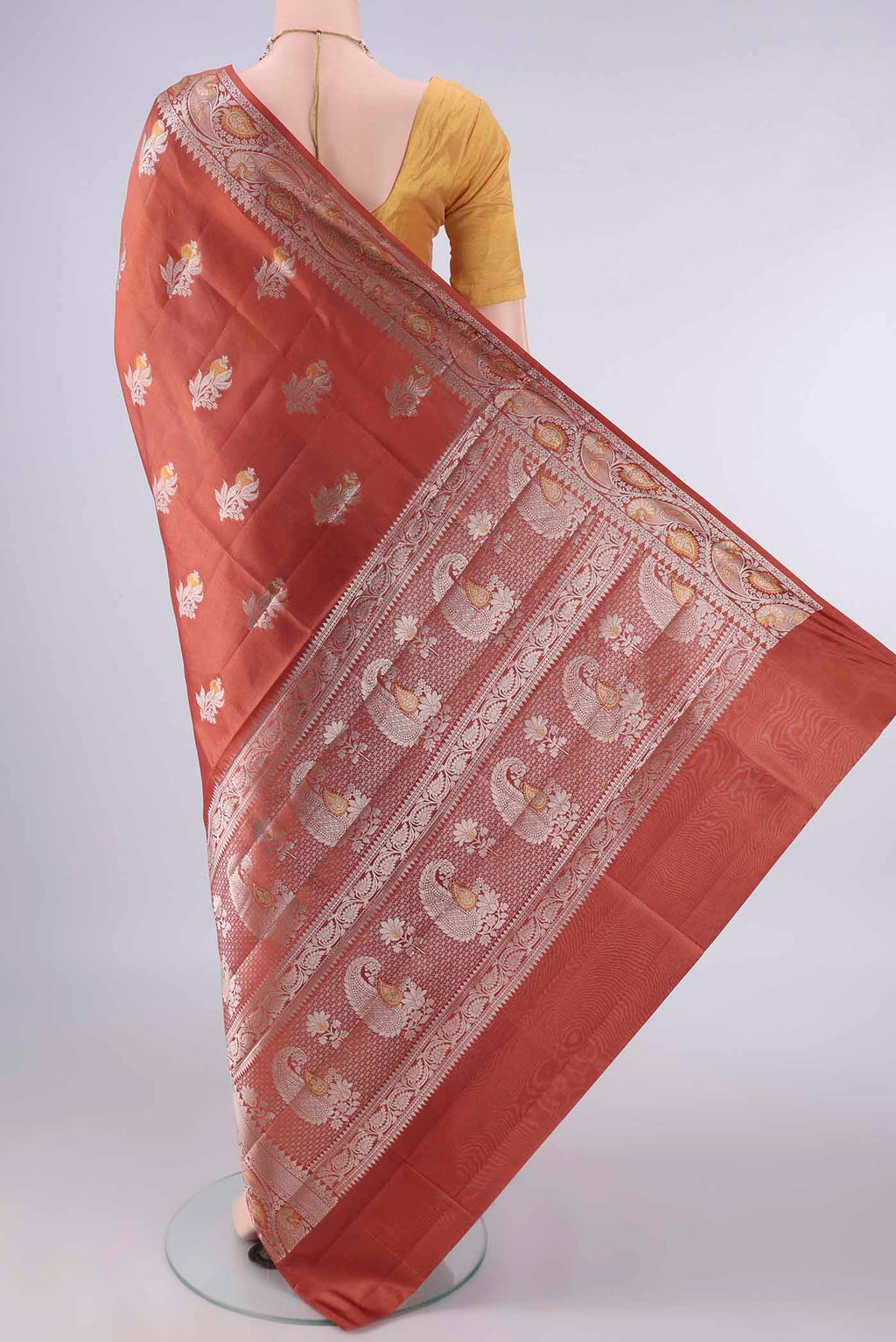 Flat view of Pure Silk Rust Banarasi Raw Saree with Zari Butta on the body and Zari Border. 