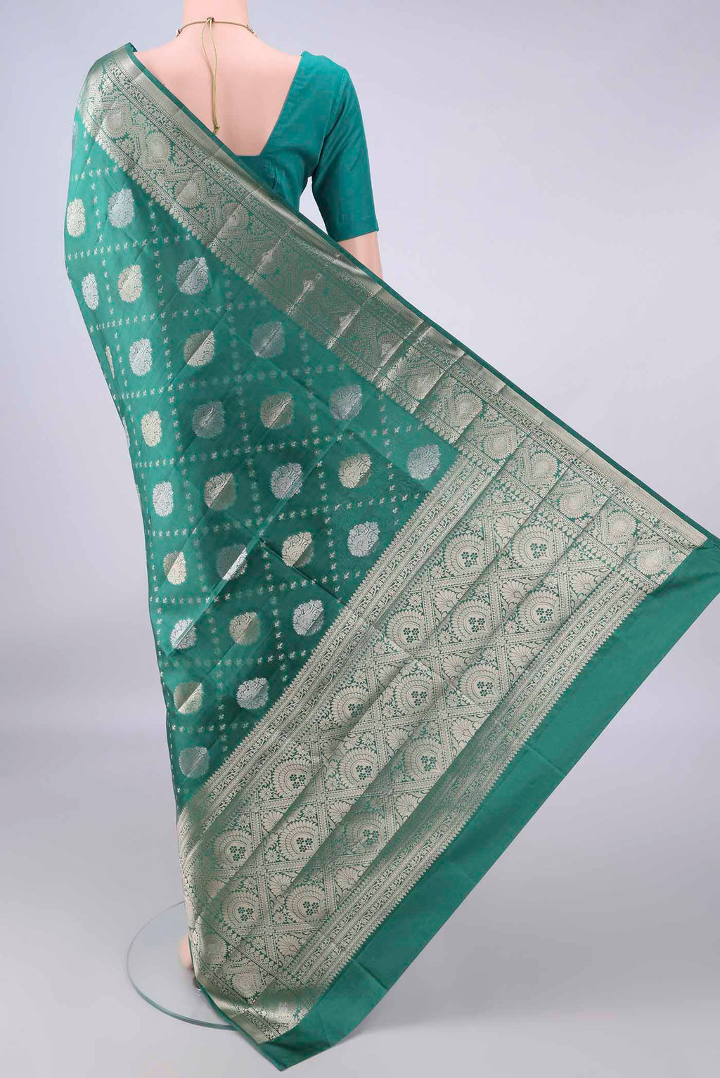 Flat view of Pure Silk Green Banarasi Raw Saree with Zari Butta on the body and Zari And Thread Border. 