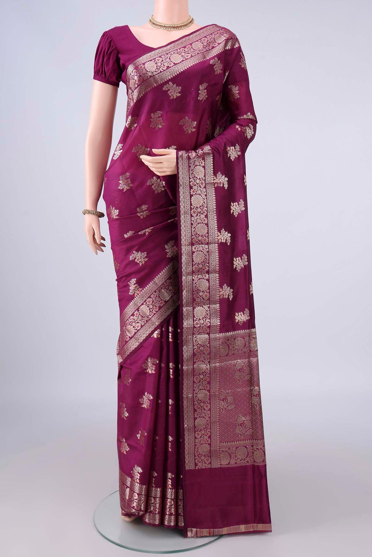 Pure Silk Magenta Banarasi Raw Saree with Zari And Thread Butta on the body and Zari Border.  displayed on a mannequin
