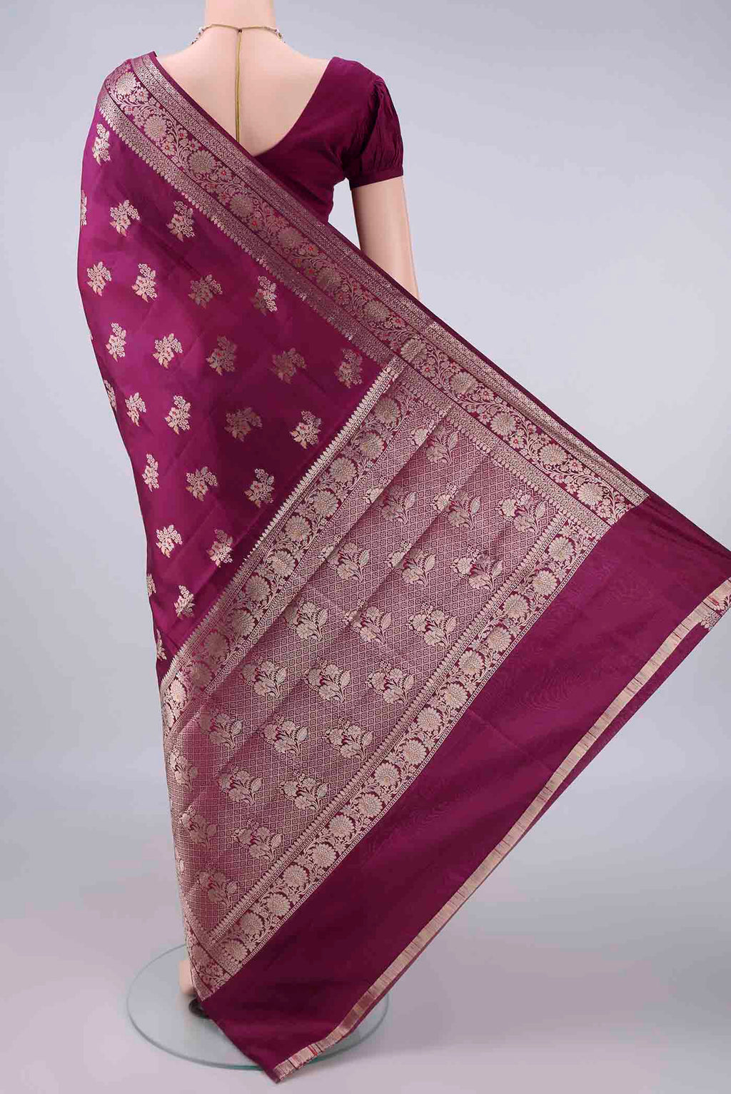 Flat view of Pure Silk Magenta Banarasi Raw Saree with Zari And Thread Butta on the body and Zari Border. 