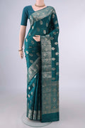 Pure Silk Teal Banarasi Raw Saree with Zari And Thread Butta on the body and Zari Border.  displayed on a mannequin