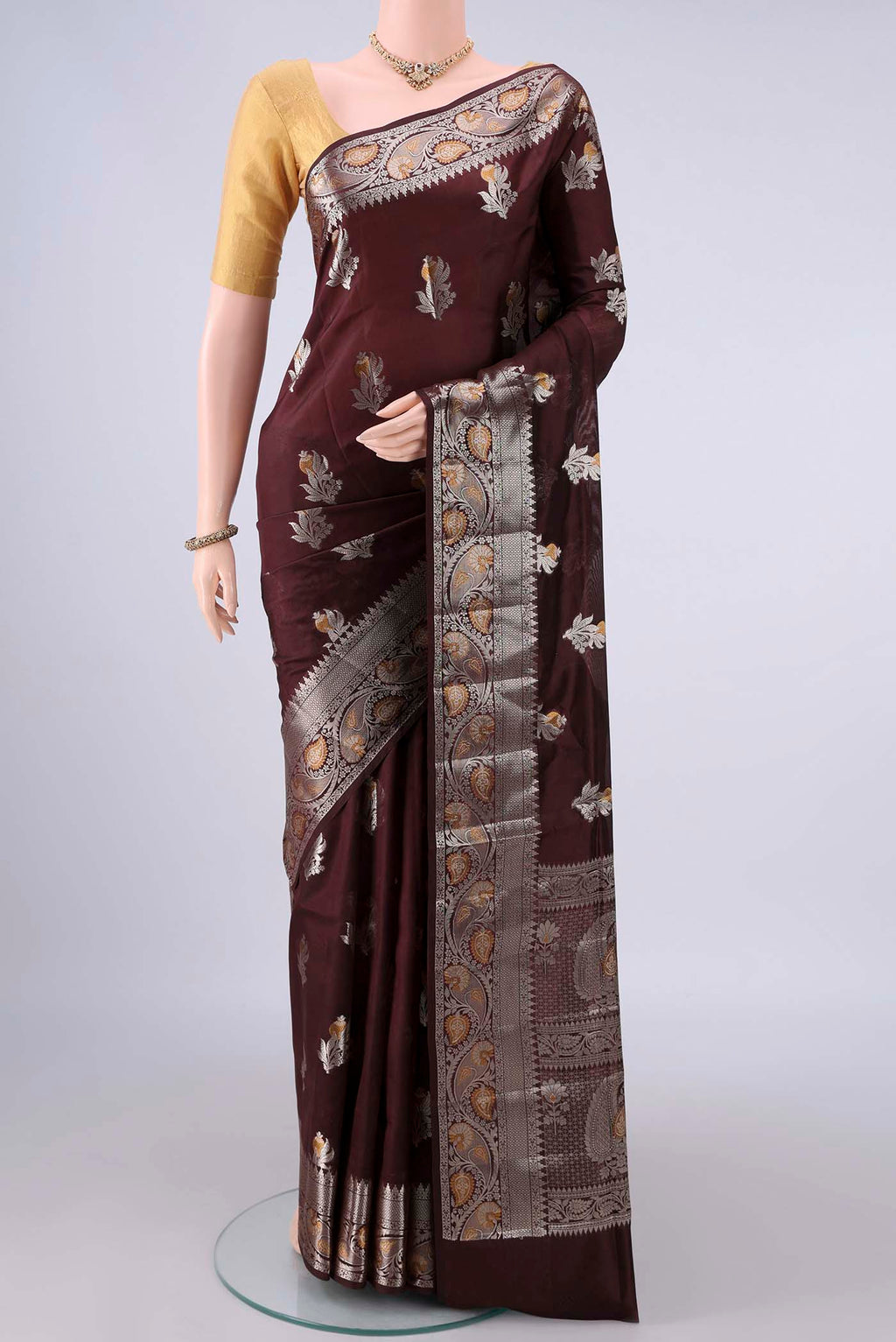 Pure Silk Brown Banarasi Raw Saree with Zari Butta on the body and Zari Border.  displayed on a mannequin