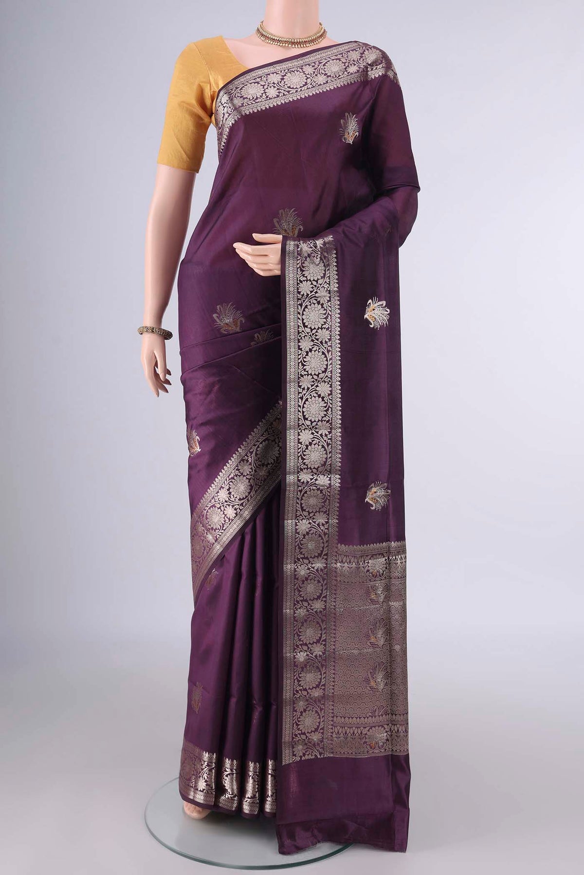Pure Silk Purple Banarasi Raw Saree with Zari Butta on the body and Zari Border.  displayed on a mannequin