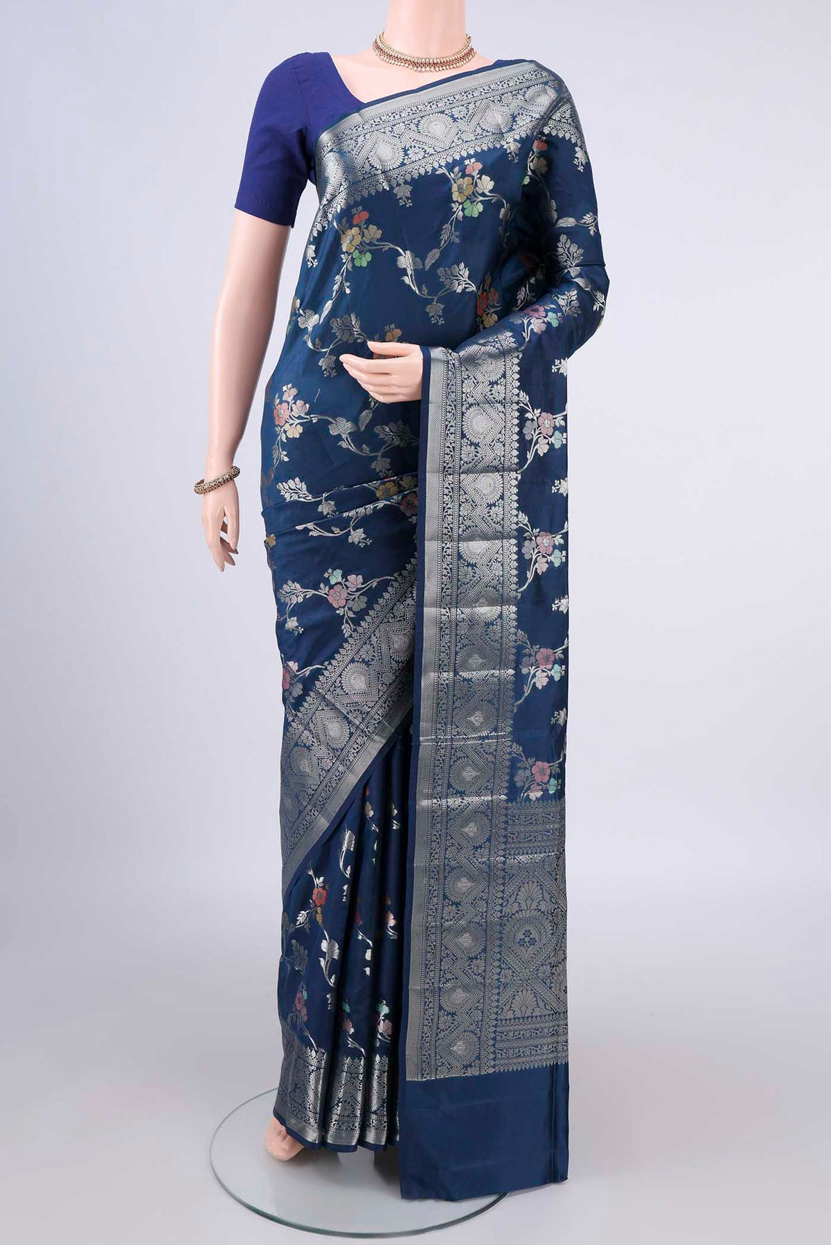Pure Silk Blue Banarasi Raw Saree with Zari And Thread Butta on the body and Zari Border.  displayed on a mannequin