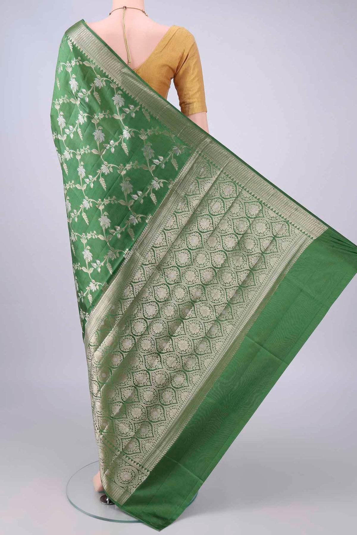 Flat view of Pure Silk Green Banarasi Raw Saree with Zari Butta on the body and Zari Border. 