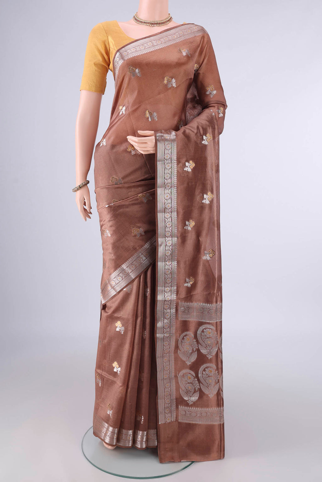 Pure Silk Bronze Banarasi Raw Saree with Zari Butta on the body and Zari Border.  displayed on a mannequin