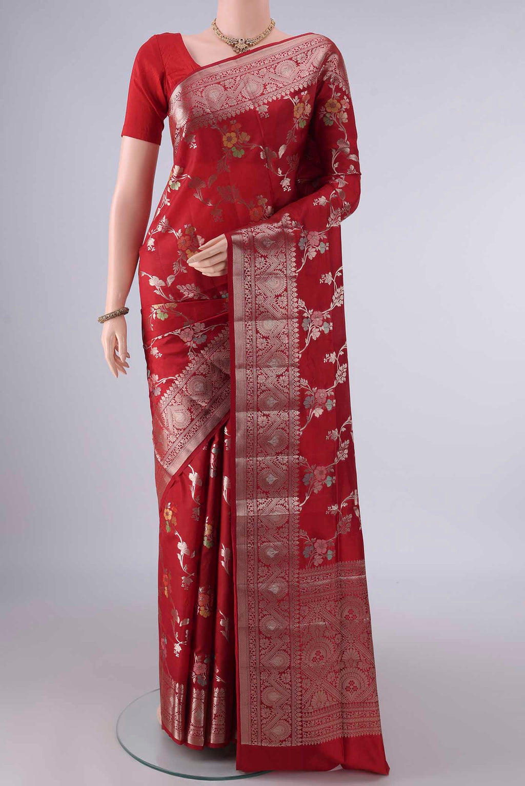 Pure Silk Red Banarasi Raw Saree with Zari And Thread Butta on the body and Zari Border.  displayed on a mannequin