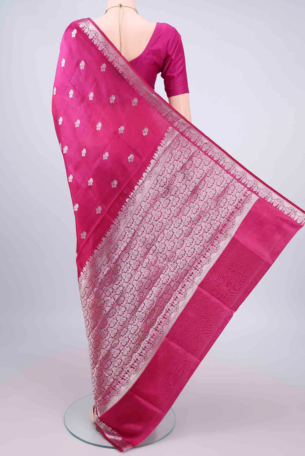 Flat view of Pure Silk Dark Pink Banarasi Raw Saree with Zari And Thread Butta on the body and Zari Border. 