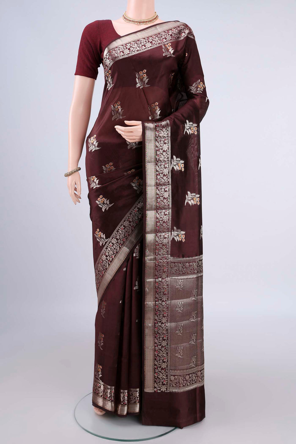 Pure Silk Brown Banarasi Raw Saree with Zari And Thread Butta on the body and Zari Border.  displayed on a mannequin