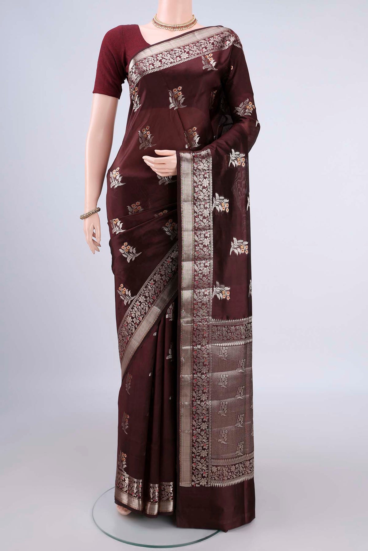 Pure Silk Brown Banarasi Raw Saree with Zari And Thread Butta on the body and Zari Border.  displayed on a mannequin
