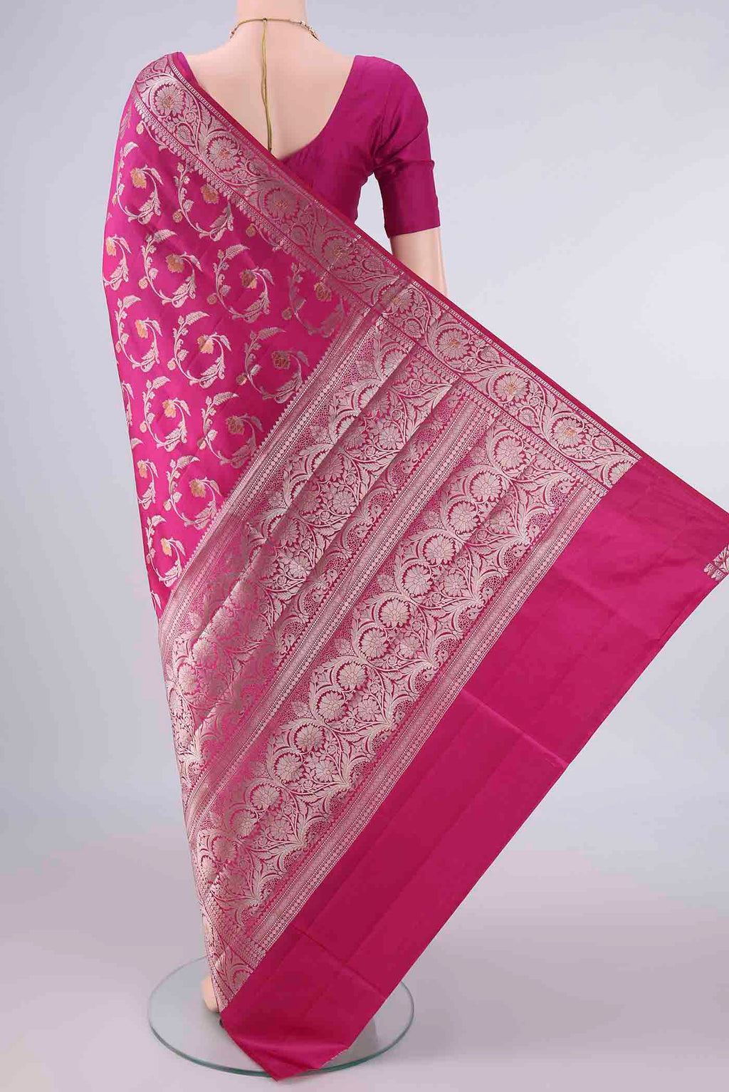 Flat view of Pure Silk Rani Pink Banarasi Raw Saree with Zari And Thread Butta on the body and Zari Border. 