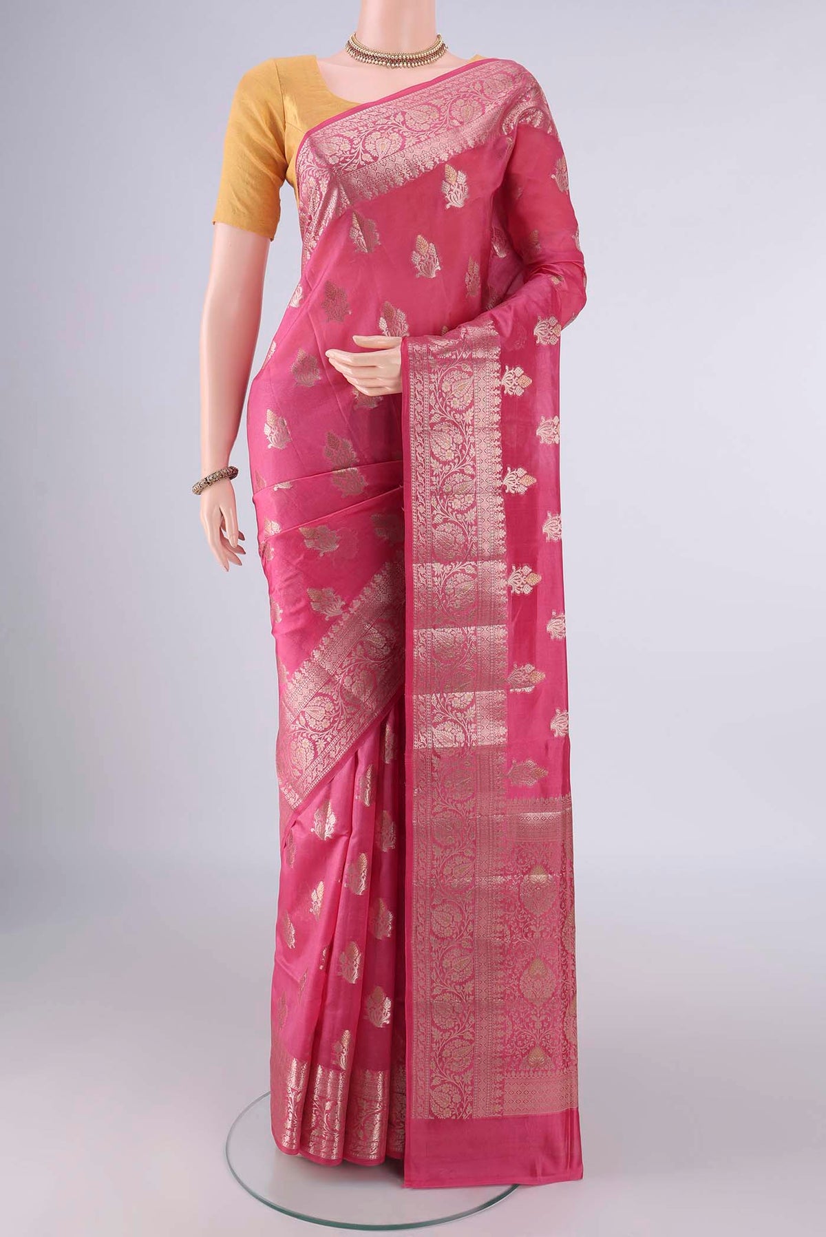 Pure Silk Pink Banarasi Raw Saree with Zari Butta on the body and Zari Border.  displayed on a mannequin