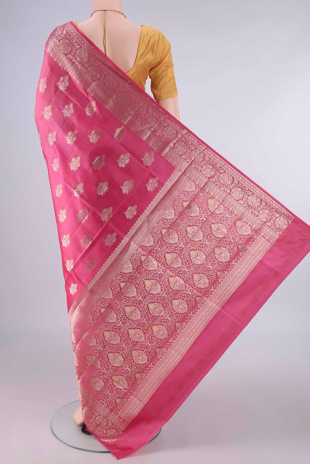 Flat view of Pure Silk Pink Banarasi Raw Saree with Zari Butta on the body and Zari Border. 