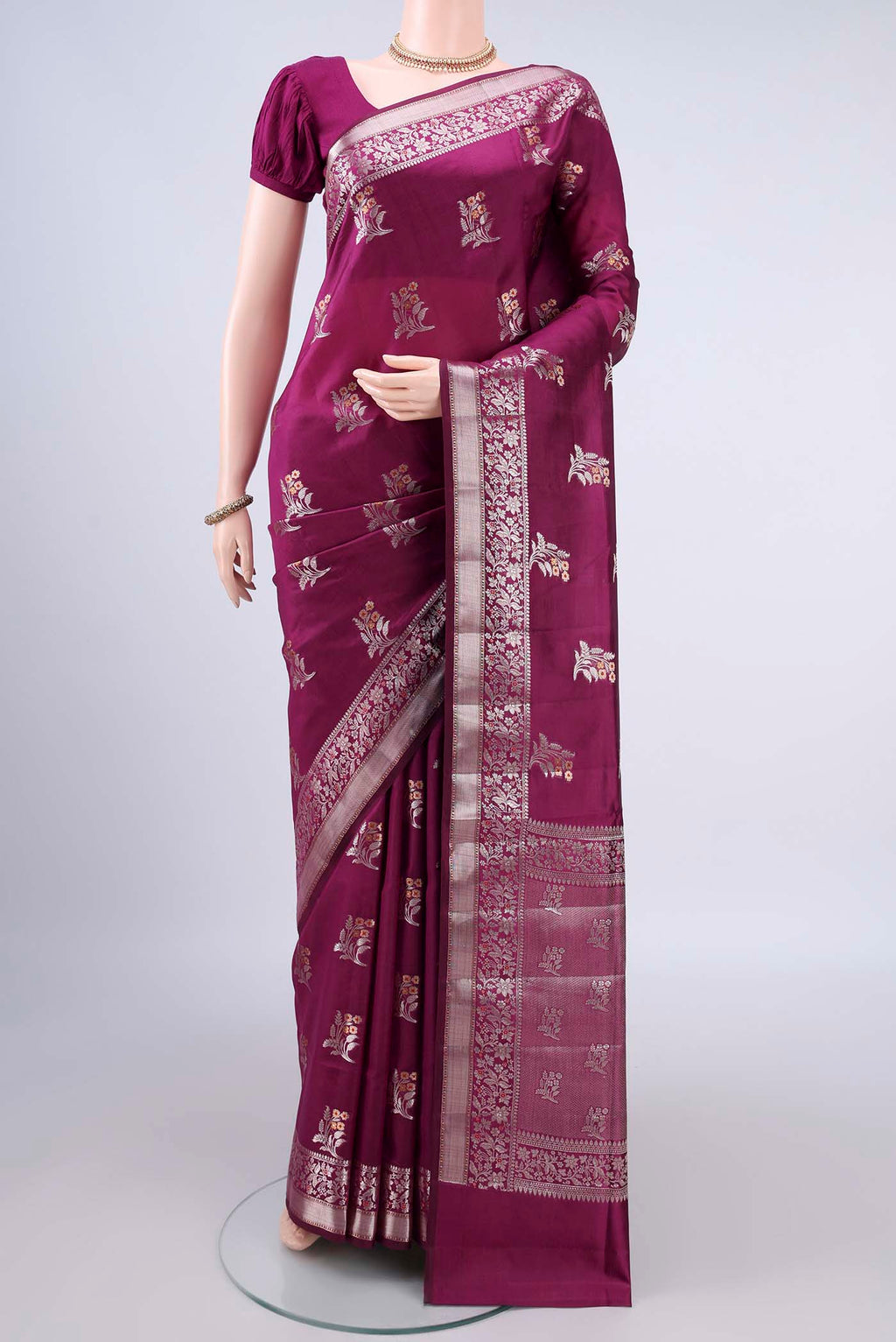 Pure Silk Magenta Banarasi Raw Saree with Zari And Thread Butta on the body and Zari Border.  displayed on a mannequin