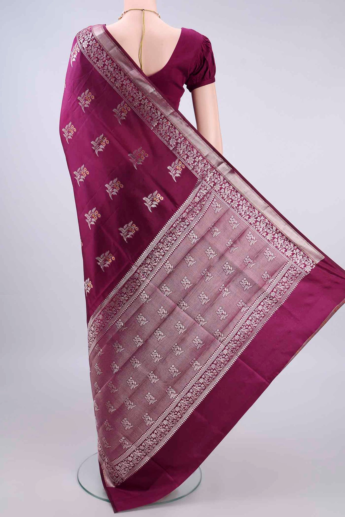 Flat view of Pure Silk Magenta Banarasi Raw Saree with Zari And Thread Butta on the body and Zari Border. 