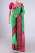Light Green Blended Bangalore Silk Saree with Plain Body and Zari Border.  displayed on a mannequin