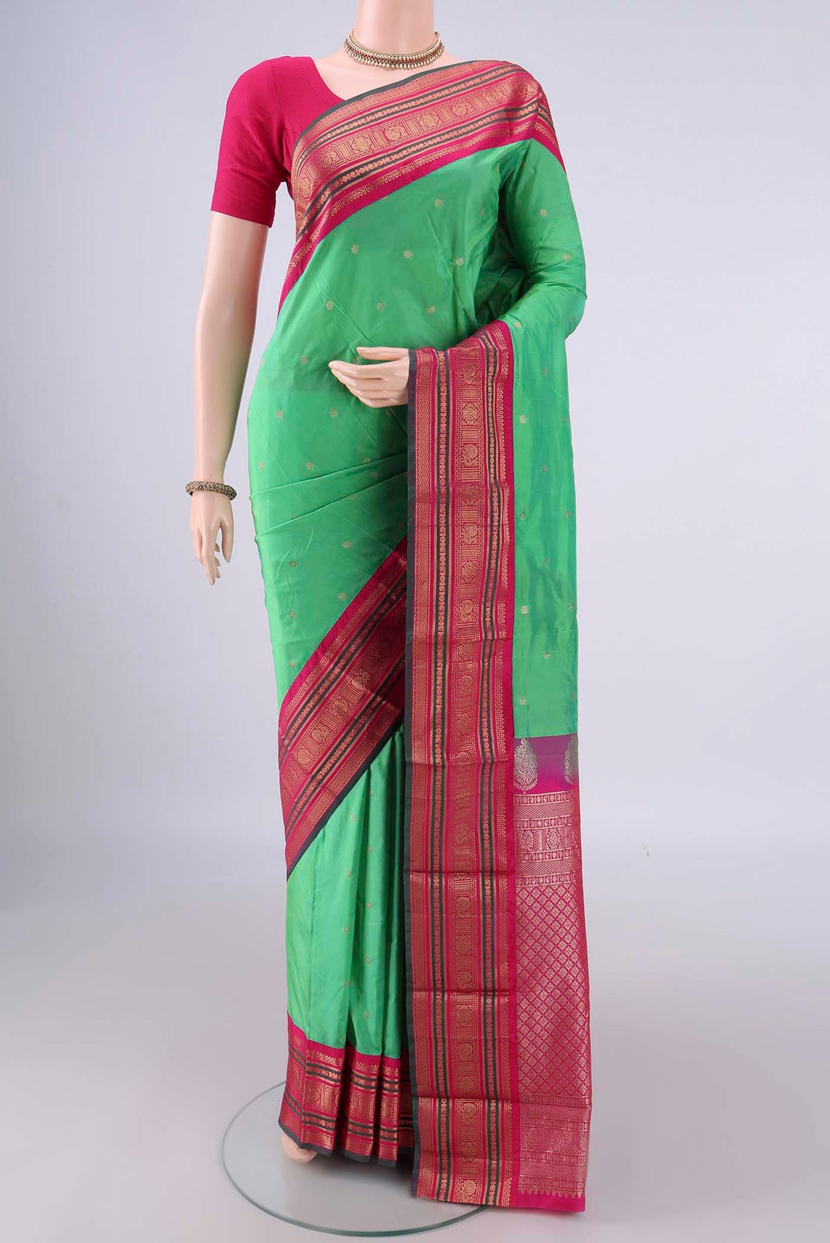 Light Green Blended Bangalore Silk Saree with Plain Body and Zari Border.  displayed on a mannequin
