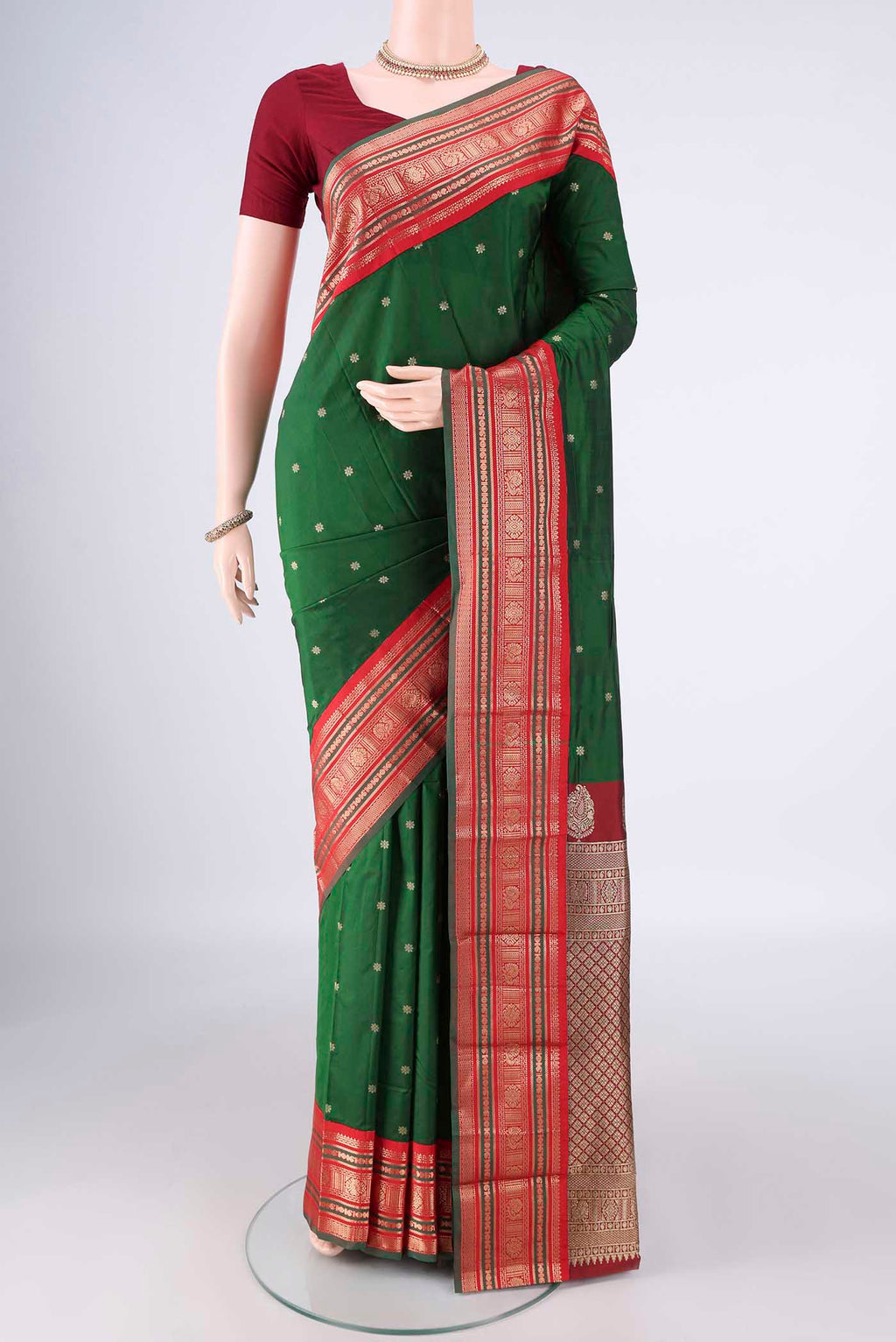 Bottle Green Blended Bangalore Silk Saree with Zari Butta on the body and Zari Border.  displayed on a mannequin