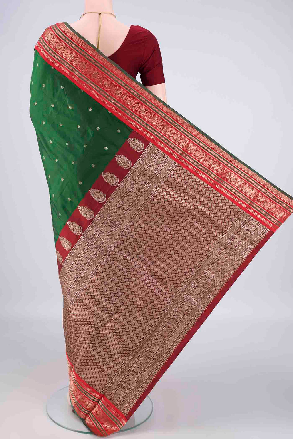 Flat view of Bottle Green Blended Bangalore Silk Saree with Zari Butta on the body and Zari Border. 