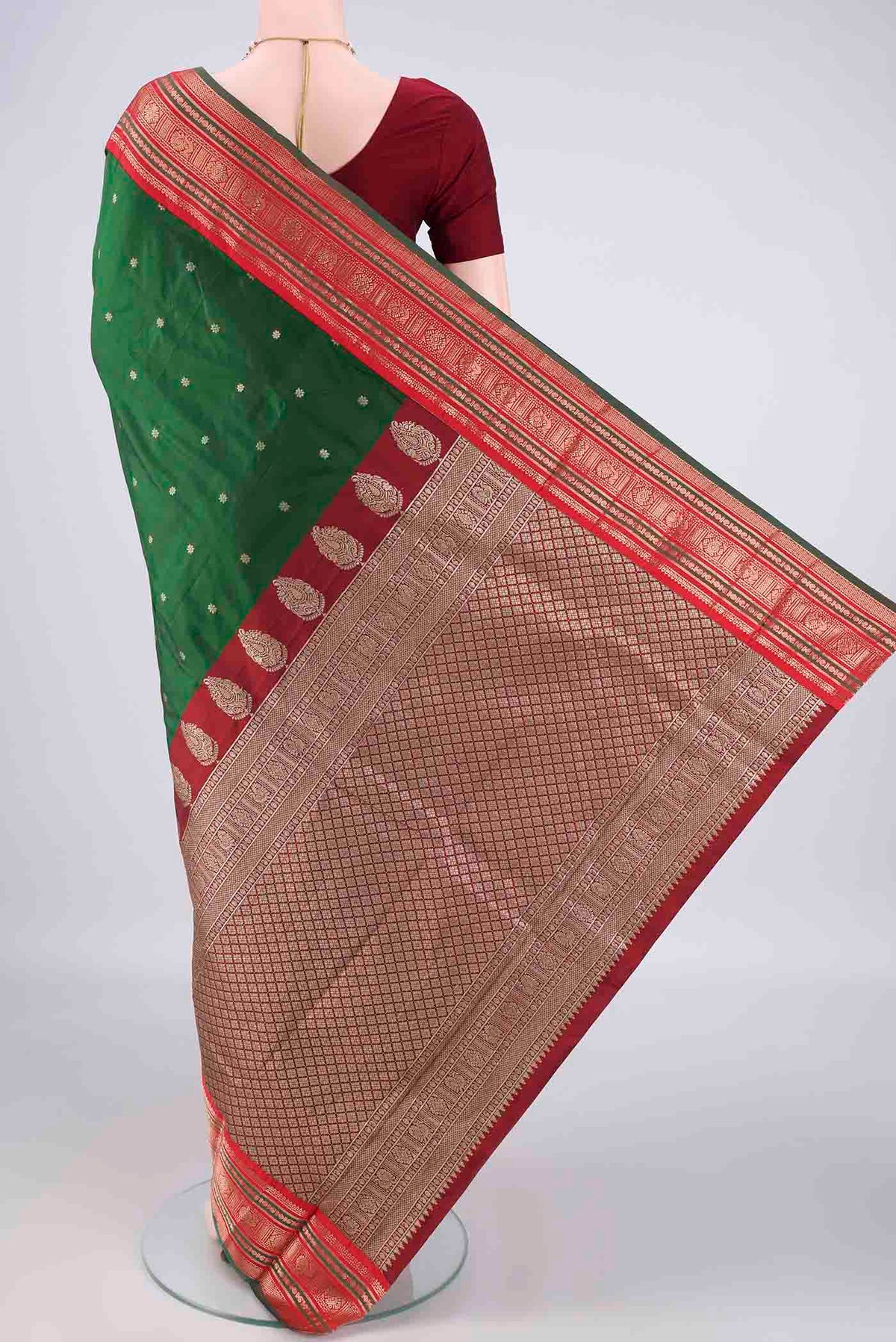Flat view of Bottle Green Blended Bangalore Silk Saree with Zari Butta on the body and Zari Border. 