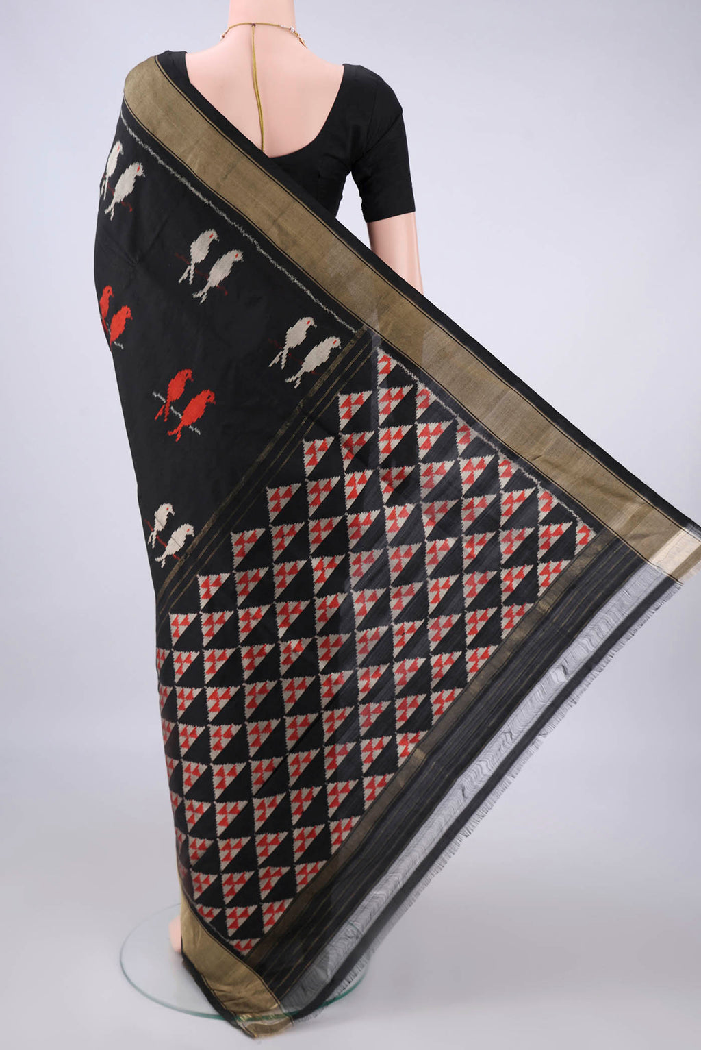 Flat view of Pure Silk Black Pochampally Saree with Ikat design on the body and Zari Border. 