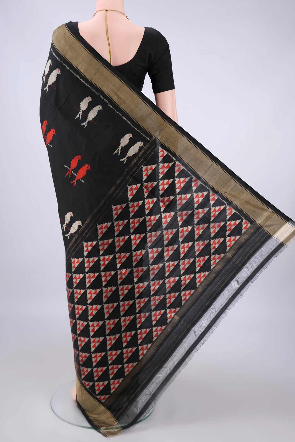 Flat view of Pure Silk Black Pochampally Saree with Ikat design on the body and Zari Border. 