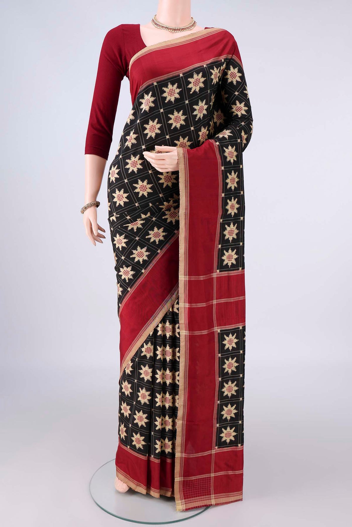 Pure Silk Black Pochampally Saree with Pure Ikat on the body and Plain Border.  displayed on a mannequin
