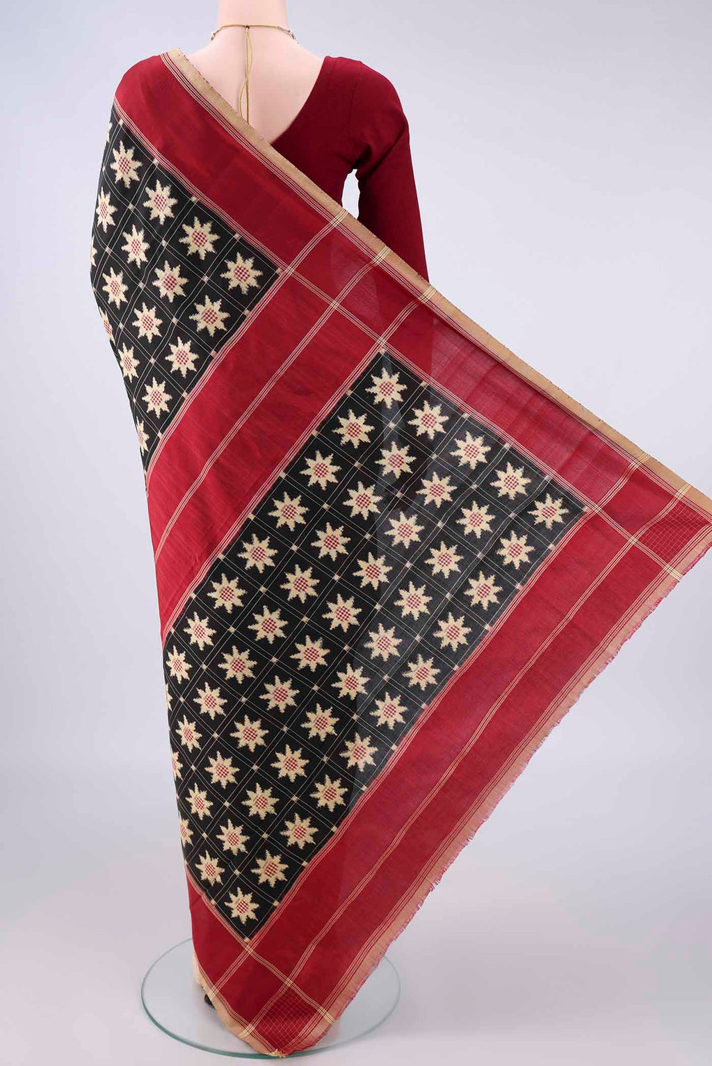 Flat view of Pure Silk Black Pochampally Saree with Pure Ikat on the body and Plain Border. 
