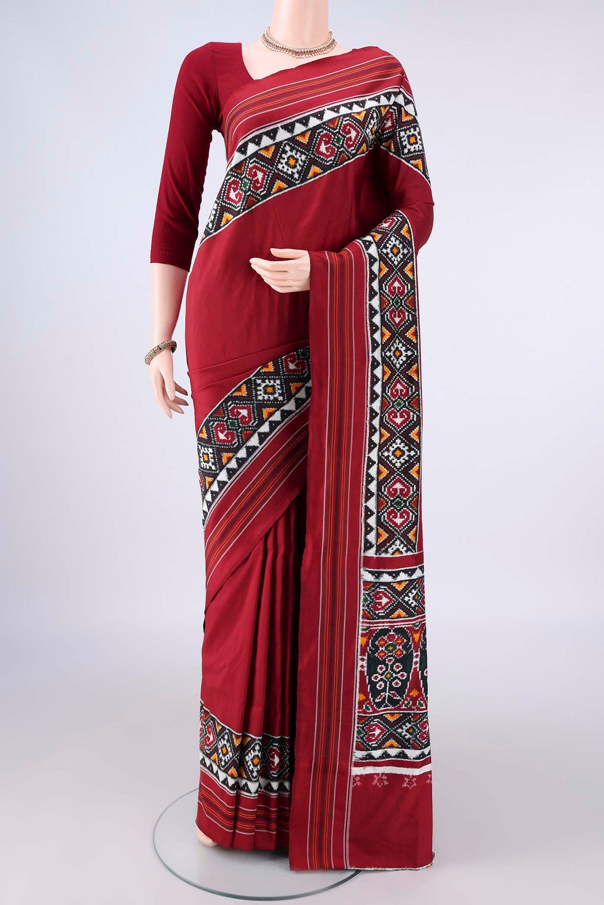 Pure Silk Maroon Double Ikat Saree with Pure Ikat on the body and Ikat Border.  displayed on a mannequin