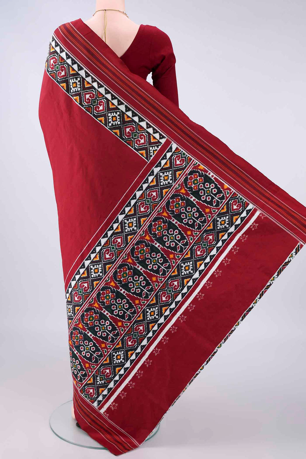 Flat view of Pure Silk Maroon Double Ikat Saree with Pure Ikat on the body and Ikat Border. 