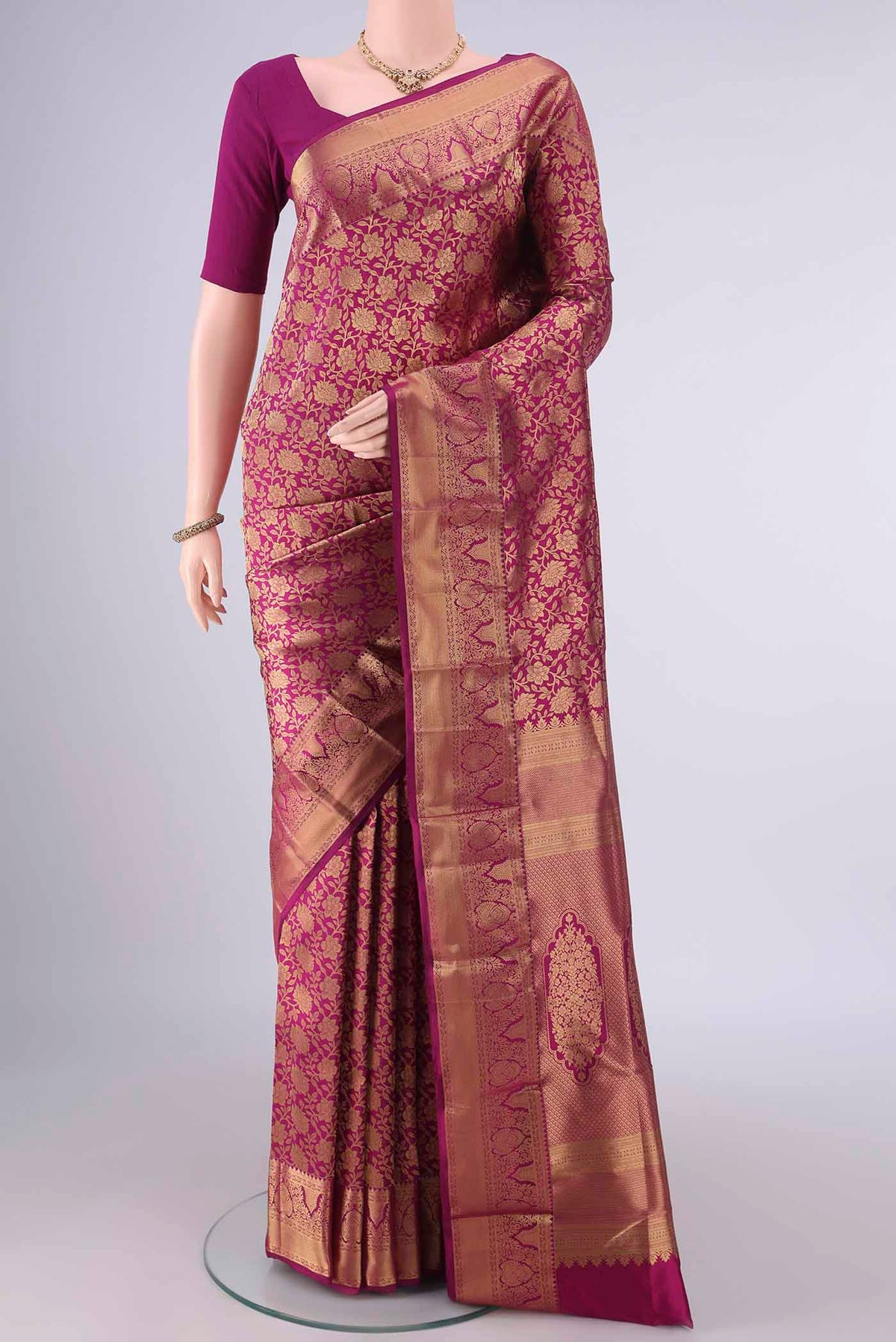 Pure Silk Magenta Kanjivaram Saree with Zari Brocade on the body and Zari Border.  displayed on a mannequin