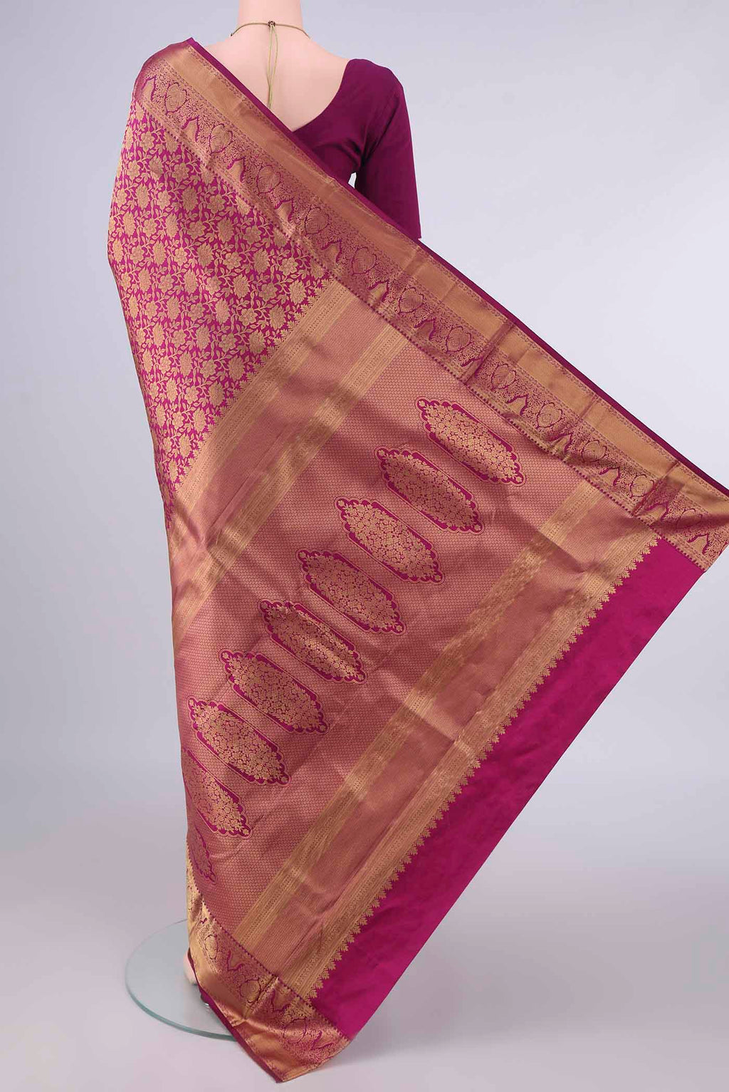 Flat view of Pure Silk Magenta Kanjivaram Saree with Zari Brocade on the body and Zari Border. 