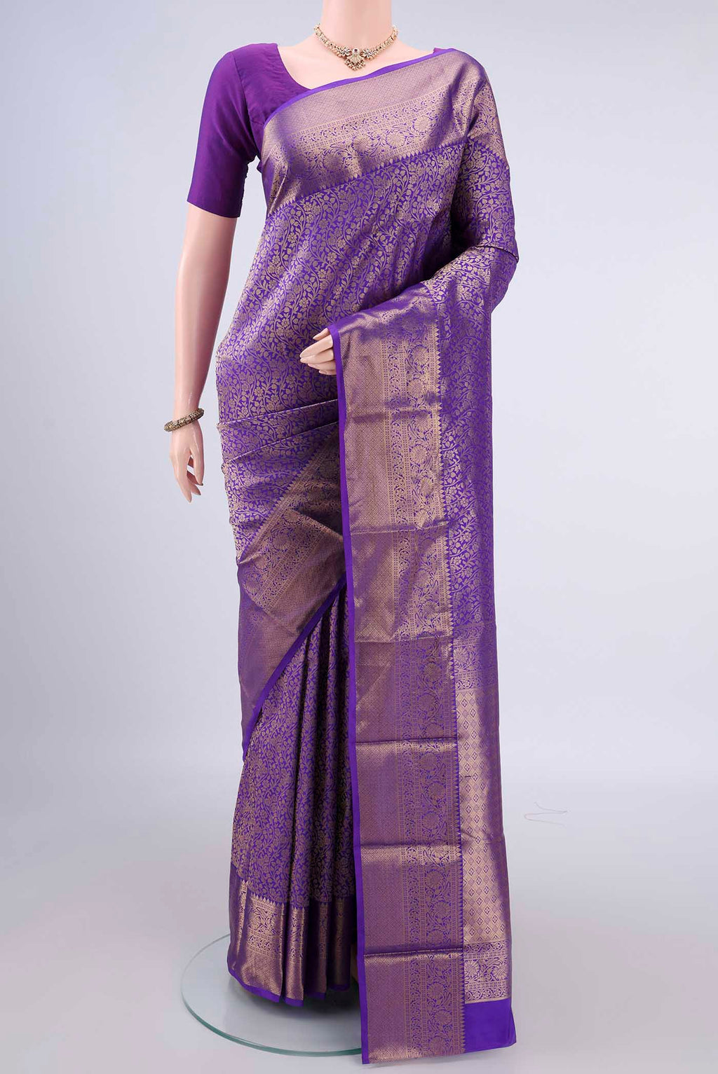 Pure Silk Purple Kanjivaram Saree with Zari Brocade on the body and Zari Border.  displayed on a mannequin