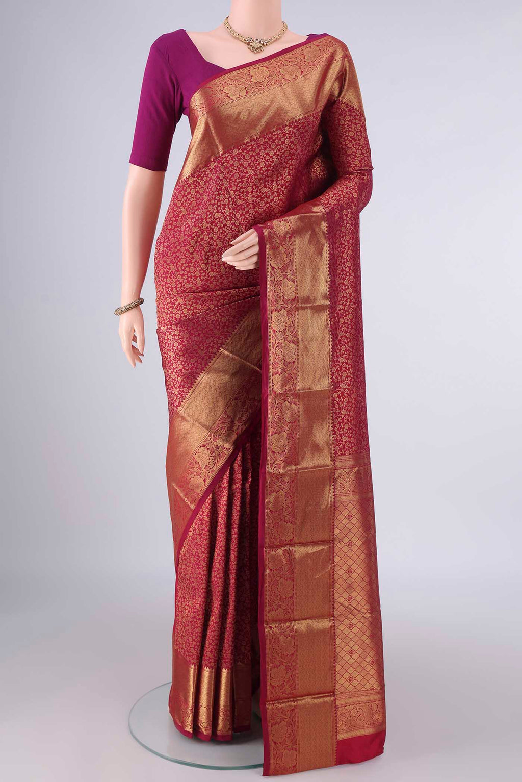 Pure Silk Maroon Kanjivaram Saree with Zari Brocade on the body and Zari Border.  displayed on a mannequin