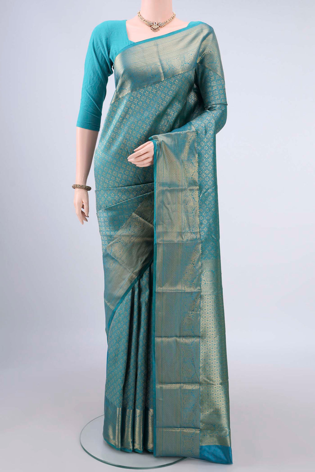 Pure Silk Sea Green Kanjivaram Saree with Zari Brocade on the body and Zari Border.  displayed on a mannequin