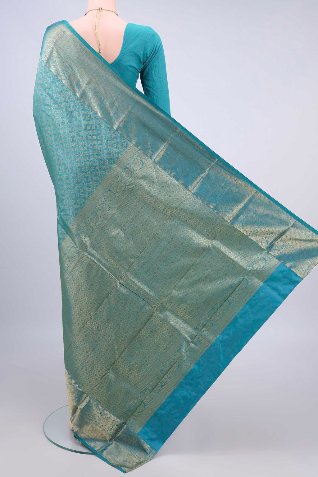 Flat view of Pure Silk Sea Green Kanjivaram Saree with Zari Brocade on the body and Zari Border. 