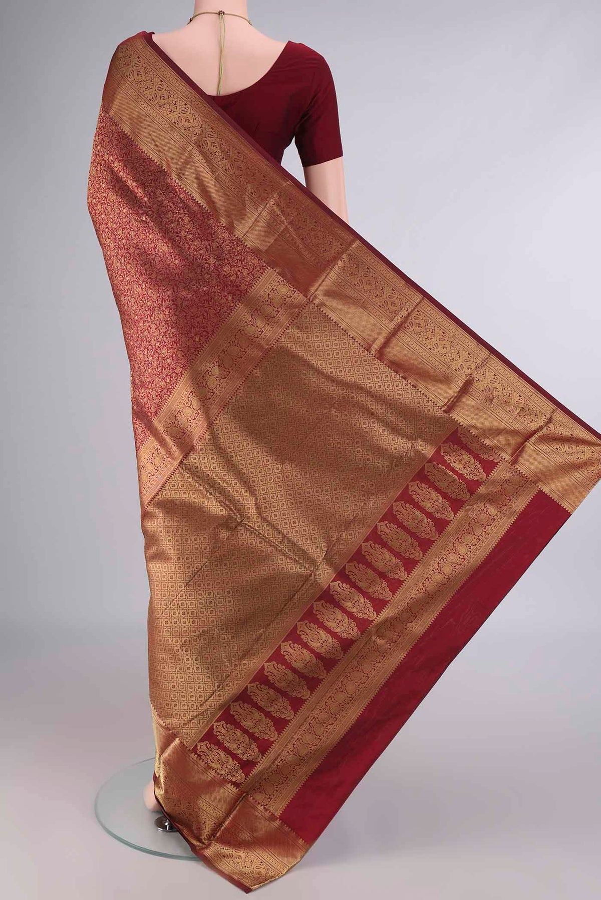 Flat view of Pure Silk Maroon Kanjivaram Saree with Zari Brocade on the body and Zari Border. 