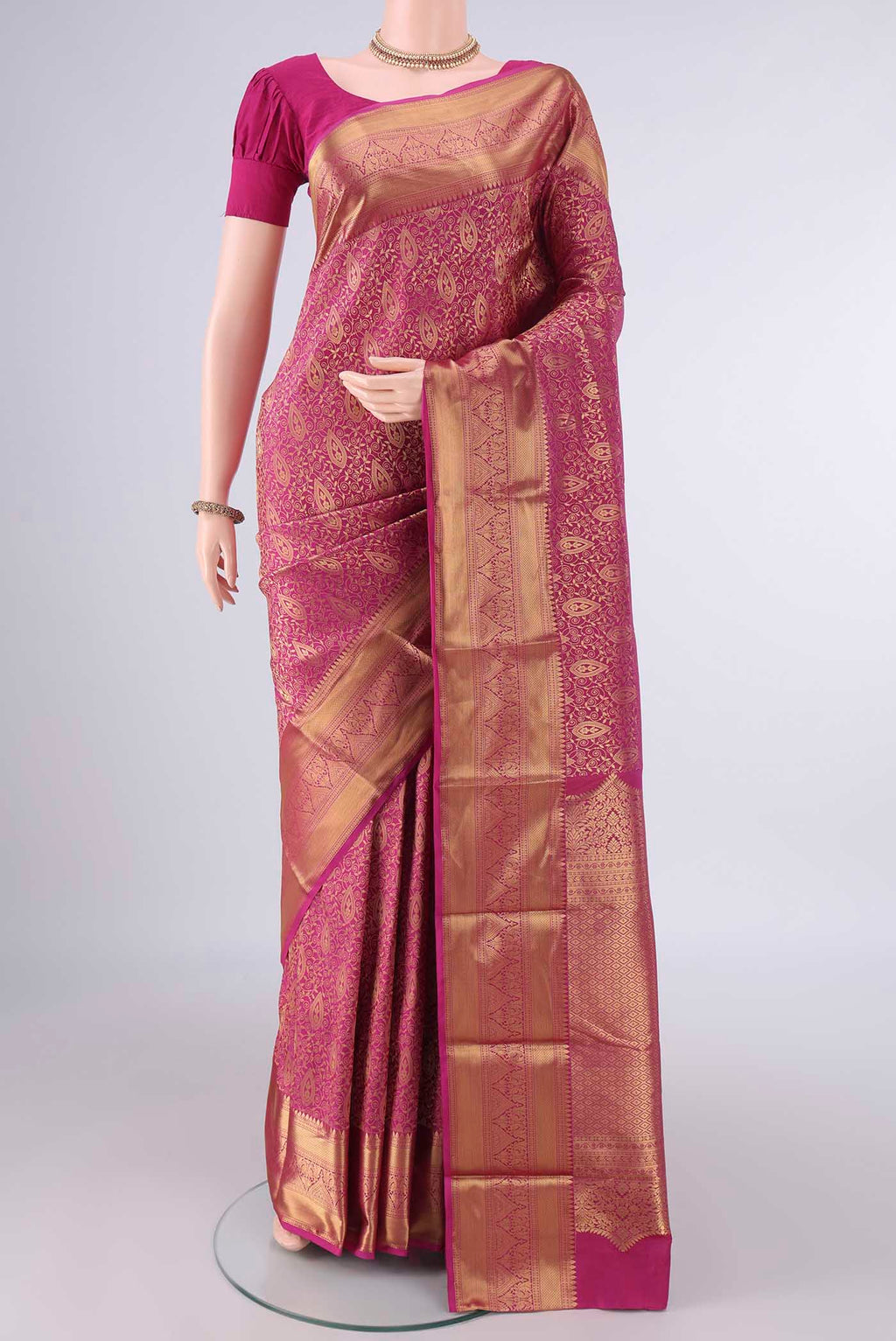 Pure Silk Rani Pink Kanjivaram Saree with Zari Brocade on the body and Zari Border.  displayed on a mannequin