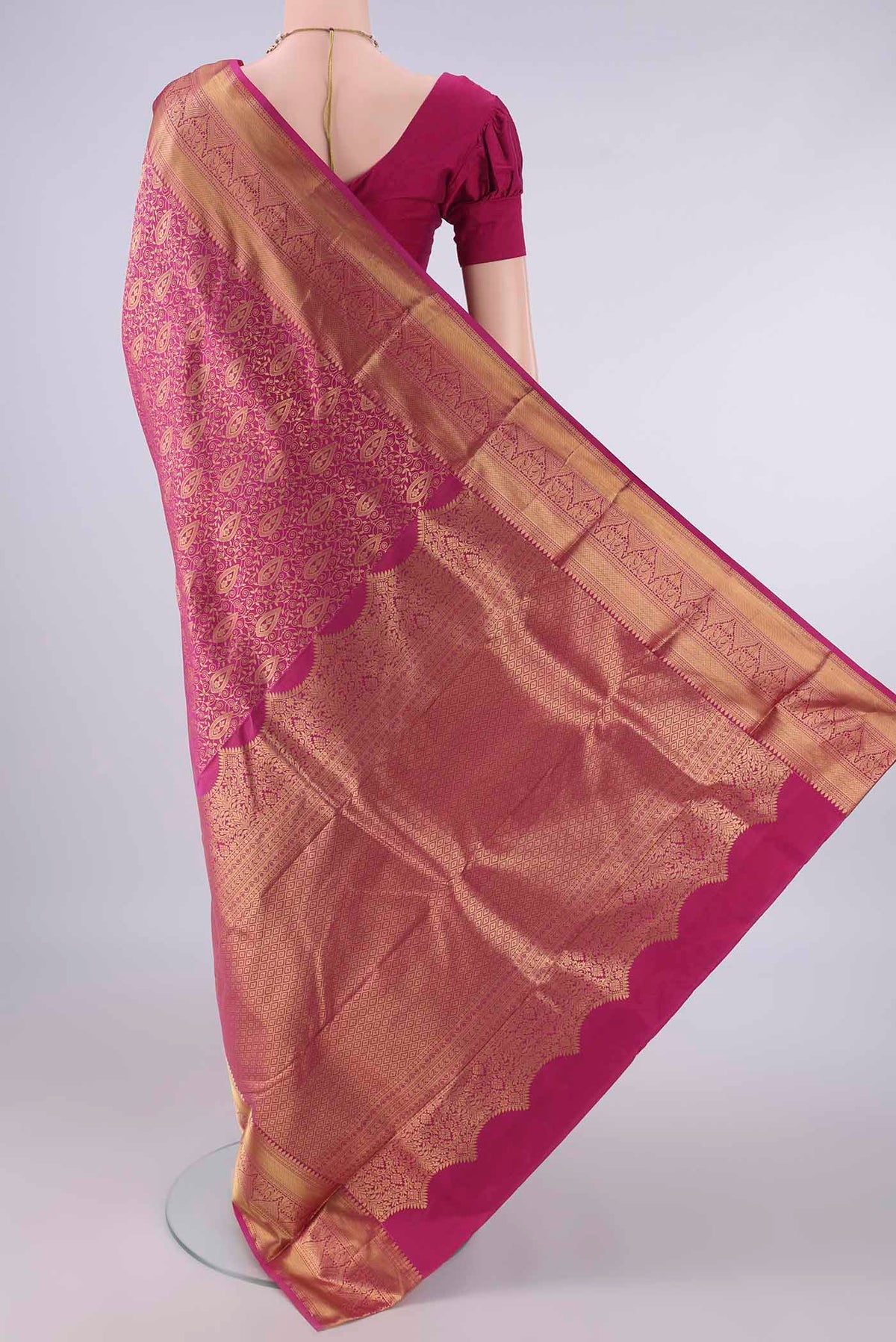 Flat view of Pure Silk Rani Pink Kanjivaram Saree with Zari Brocade on the body and Zari Border. 