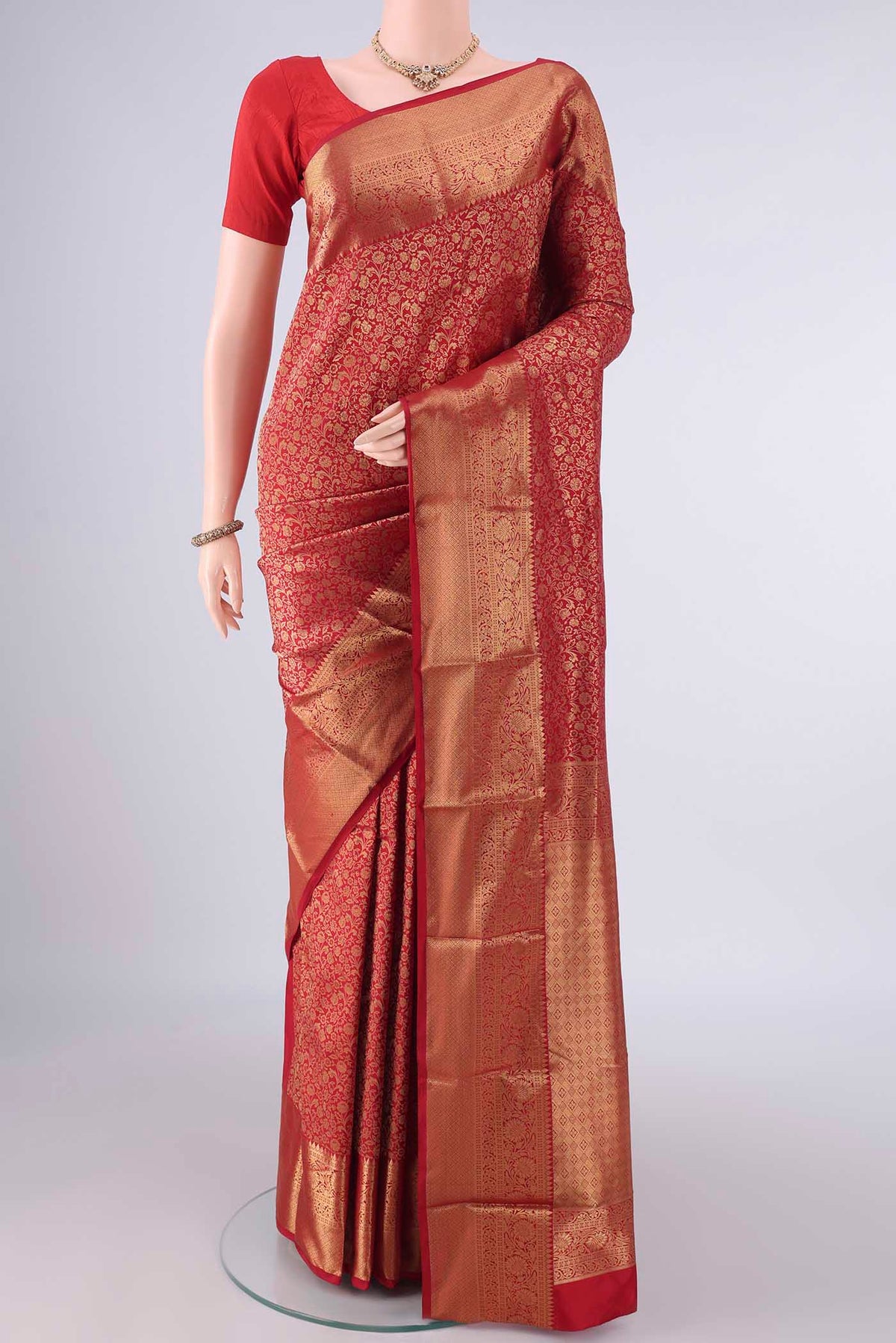 Pure Silk Red Kanjivaram Saree with Zari Brocade on the body and Zari Border.  displayed on a mannequin
