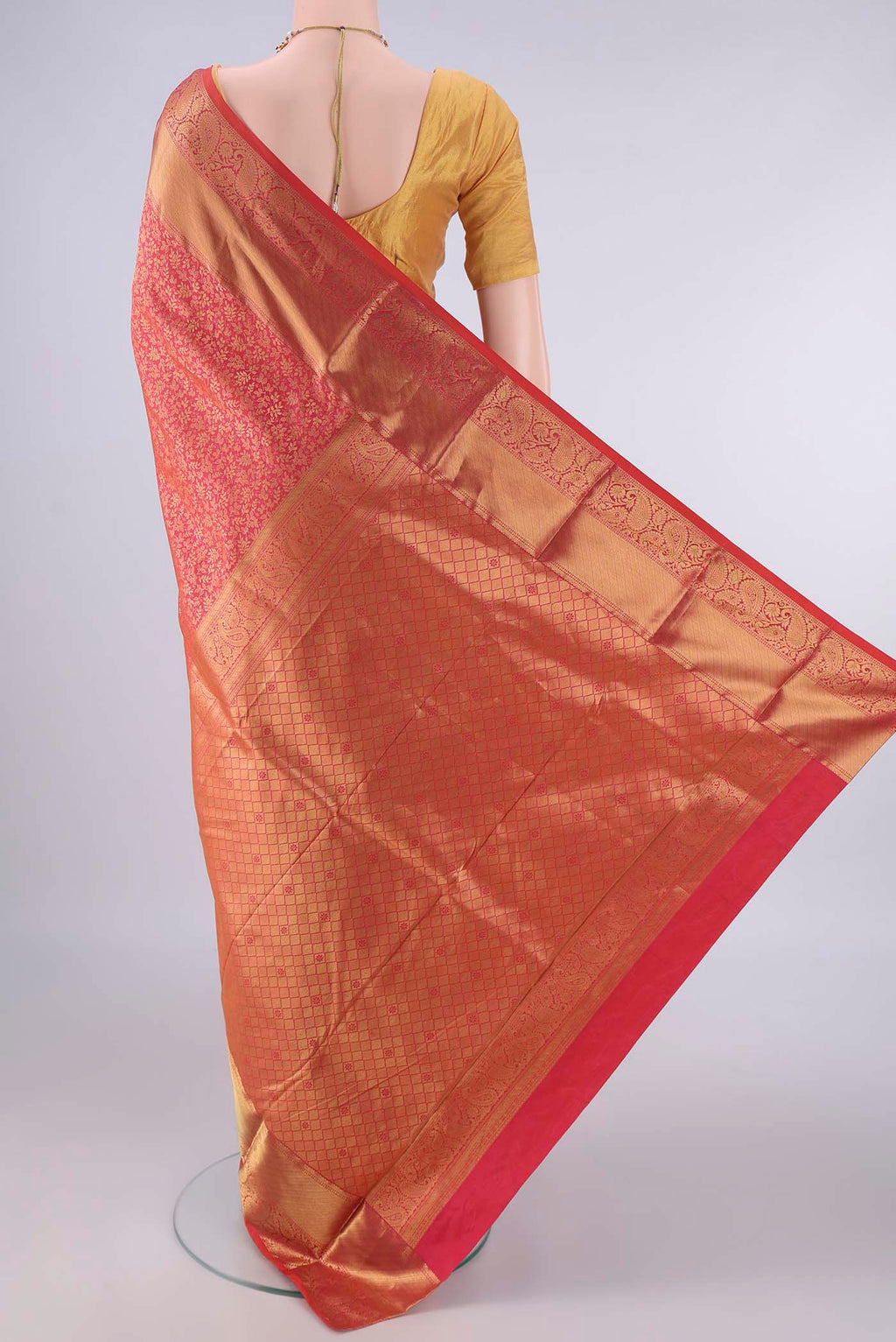 Flat view of Pure Silk Coral Kanjivaram Saree with Zari Brocade on the body and Zari Border. 