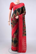 Pure Silk Black Pochampally Saree with Pure Ikat on the body and Zari Border.  displayed on a mannequin