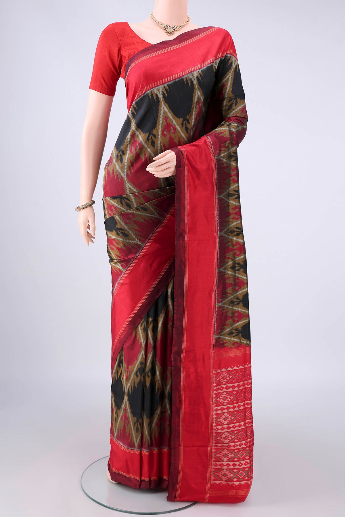 Pure Silk Black Pochampally Saree with Pure Ikat on the body and Zari Border.  displayed on a mannequin